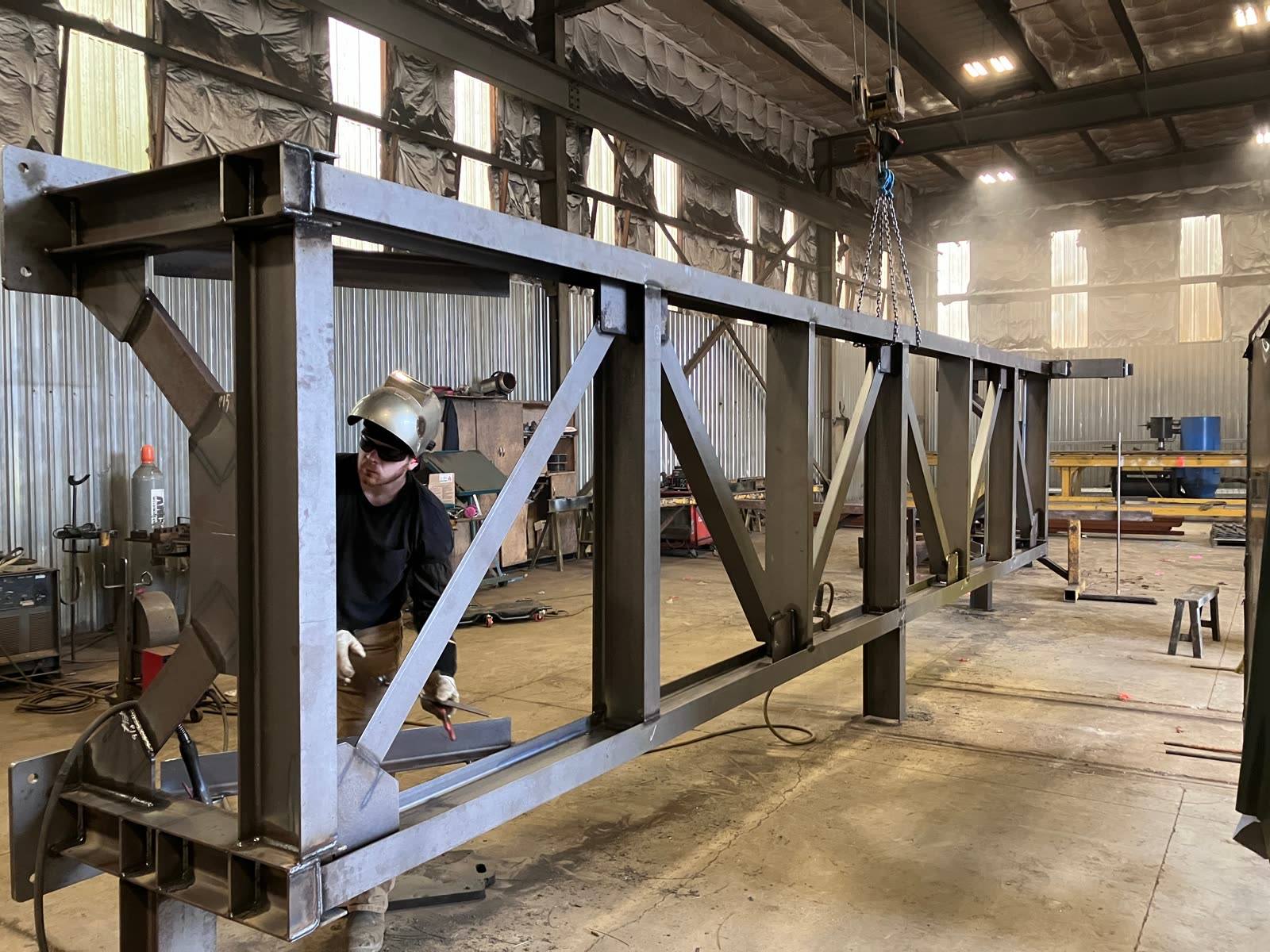 Fitters assembling a steel truss in the shop
